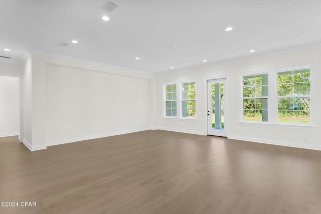 empty room with ornamental molding and dark hardwood / wood-style flooring