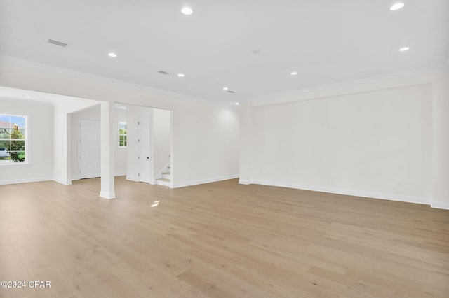 interior space with light wood-type flooring and crown molding