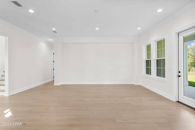 empty room with light wood-type flooring and ornamental molding