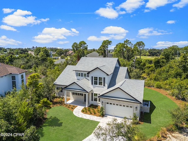 view of front of property featuring a garage and a front lawn