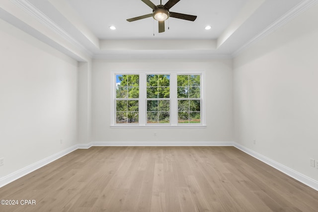 spare room with crown molding, light hardwood / wood-style floors, and ceiling fan