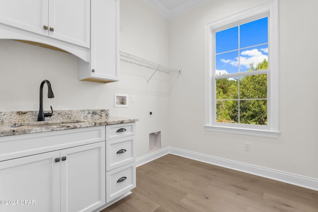 laundry room with ornamental molding, sink, hookup for an electric dryer, hookup for a washing machine, and light hardwood / wood-style floors