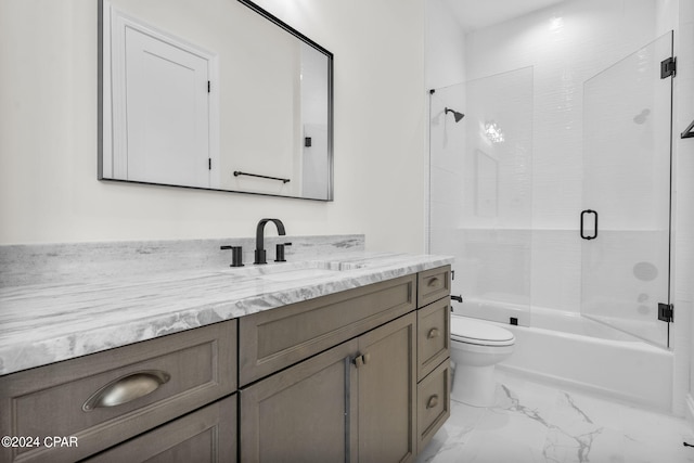 full bathroom with combined bath / shower with glass door, vanity, and toilet