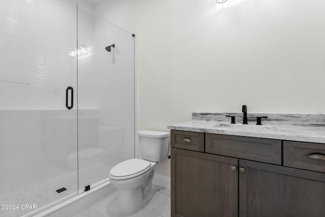 bathroom featuring a shower with door, toilet, and vanity