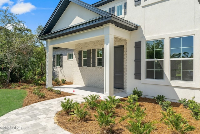 view of exterior entry featuring a porch