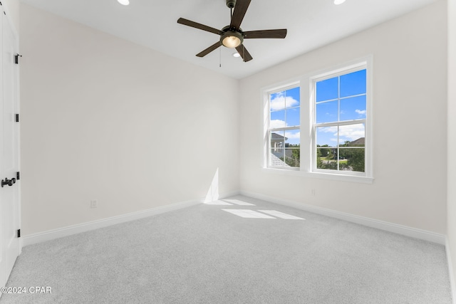 unfurnished room featuring light carpet and ceiling fan