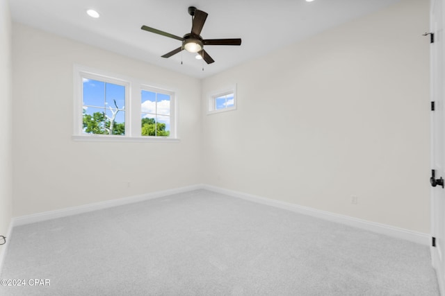 spare room with light carpet and ceiling fan