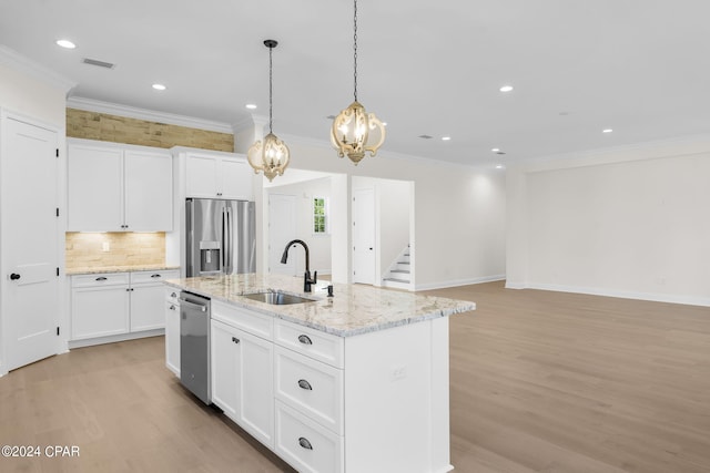 kitchen featuring light wood-type flooring, sink, an island with sink, white cabinets, and stainless steel appliances