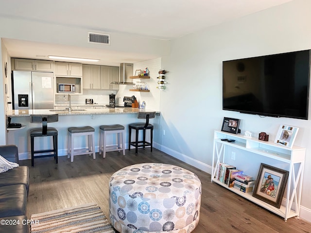 living room featuring sink and dark hardwood / wood-style floors