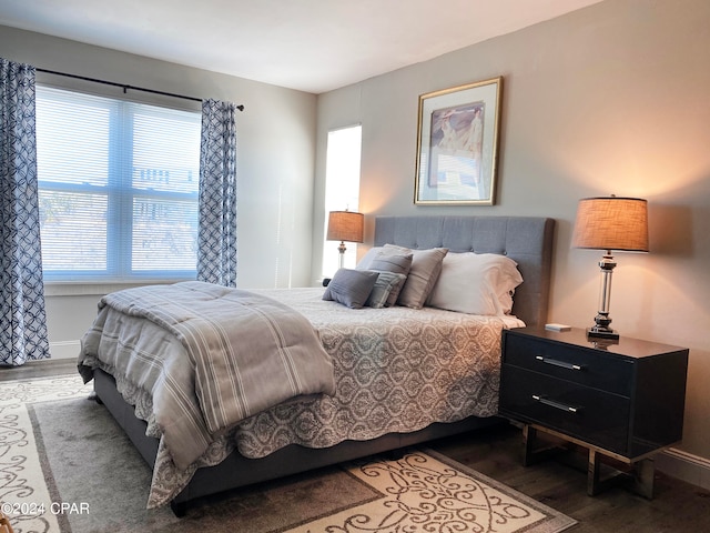 bedroom with dark hardwood / wood-style floors