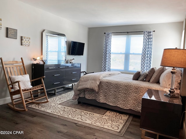 bedroom with dark wood-type flooring