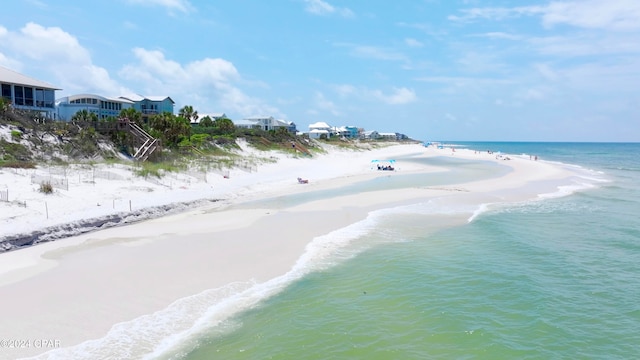 bird's eye view with a water view and a beach view