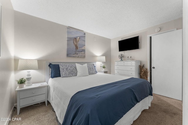 bedroom featuring light colored carpet and a textured ceiling