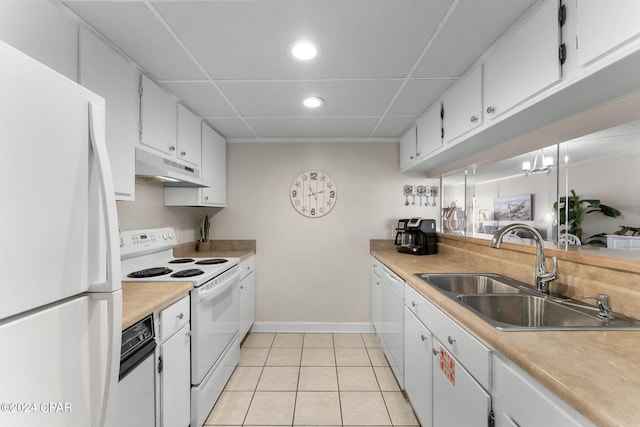 kitchen with white appliances, under cabinet range hood, white cabinetry, and light countertops