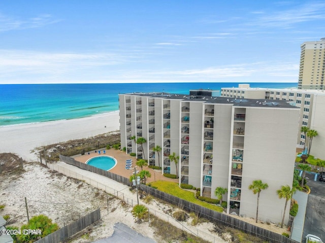 drone / aerial view with a water view and a beach view