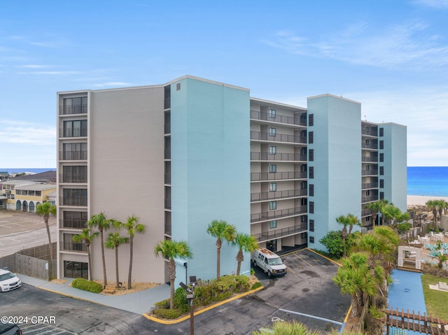 view of property featuring uncovered parking and a water view