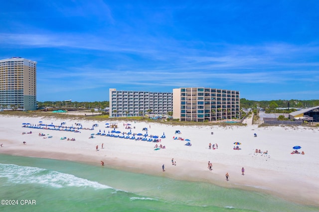 drone / aerial view featuring a beach view and a water view