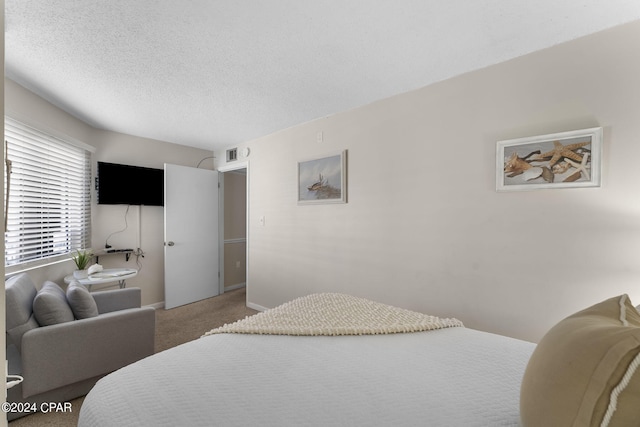 carpeted bedroom featuring visible vents, a textured ceiling, and baseboards