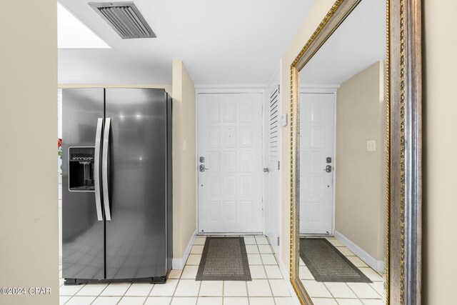 kitchen featuring stainless steel refrigerator with ice dispenser and light tile patterned floors