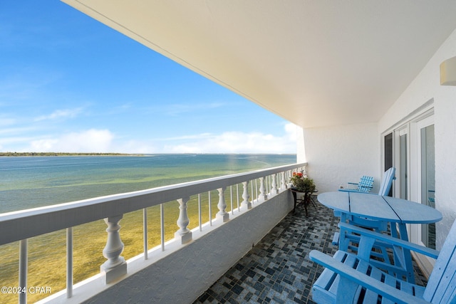 balcony featuring a water view and a view of the beach