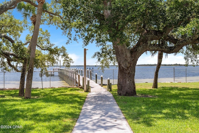 dock area featuring a water view and a lawn