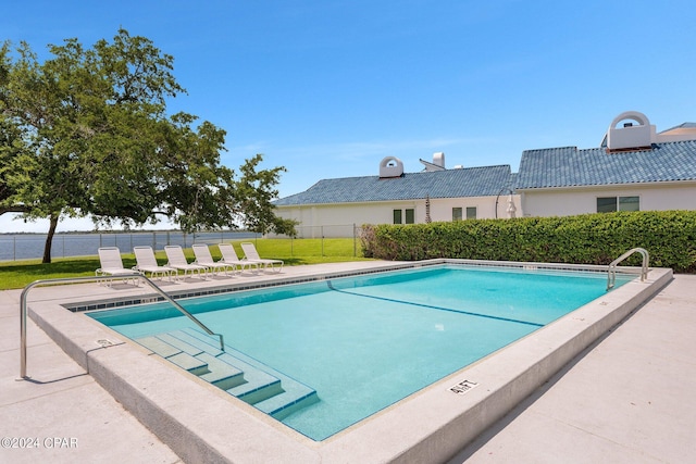 pool featuring fence and a patio