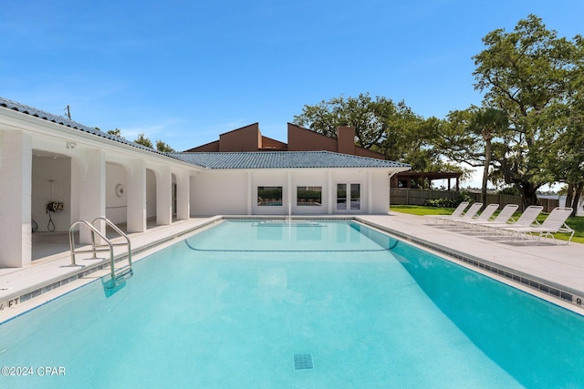 pool featuring fence and a patio