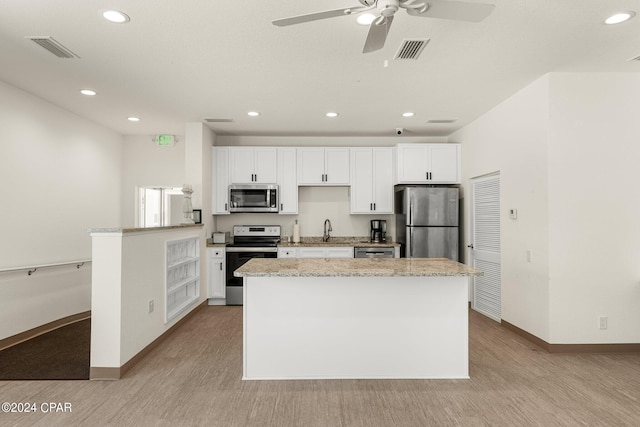 kitchen with light wood-style flooring, visible vents, stainless steel appliances, and a sink