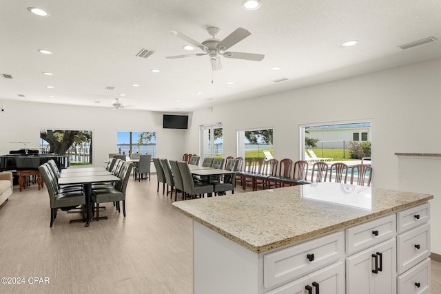 kitchen featuring plenty of natural light, visible vents, and white cabinets