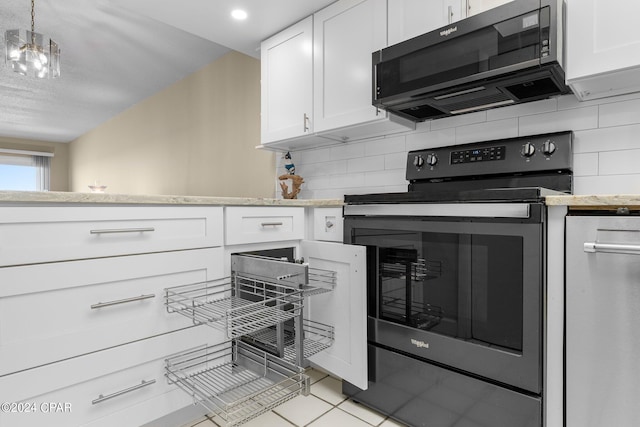 kitchen featuring tasteful backsplash, white cabinets, and stainless steel electric stove