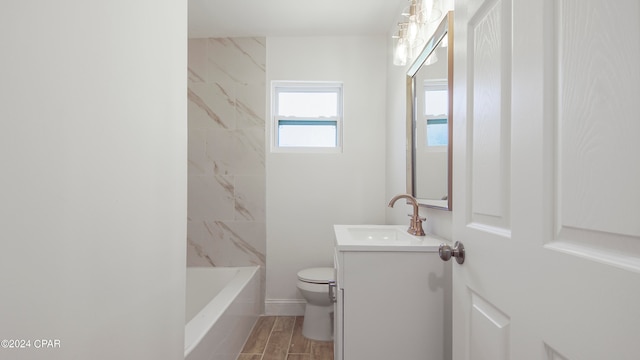 bathroom with vanity, toilet, and hardwood / wood-style flooring