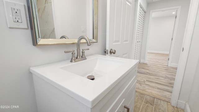 bathroom featuring vanity and hardwood / wood-style flooring