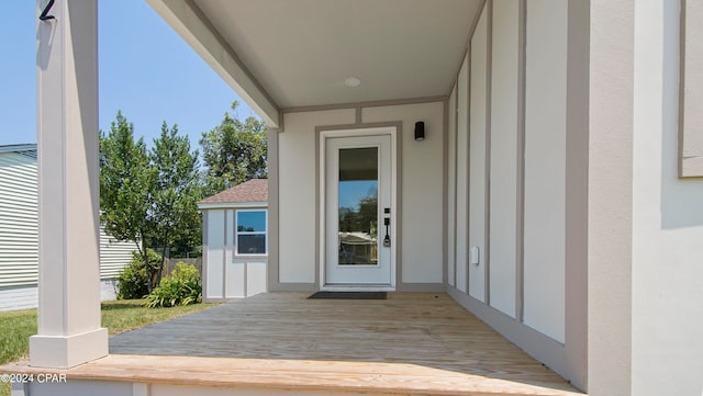 property entrance featuring a wooden deck