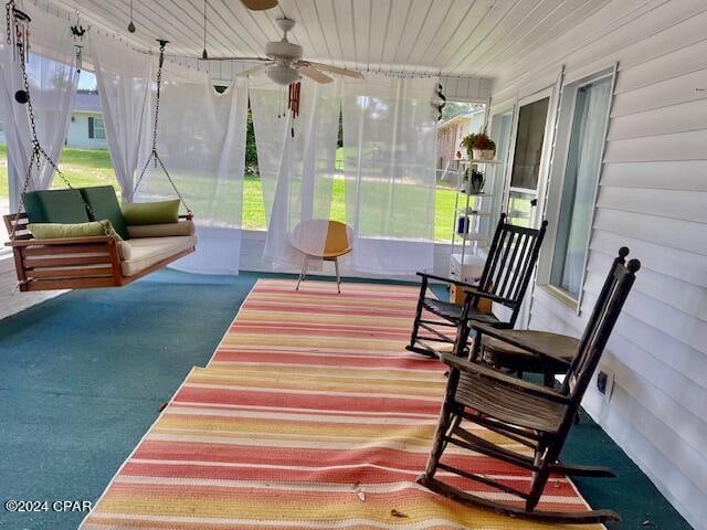 sunroom / solarium featuring ceiling fan