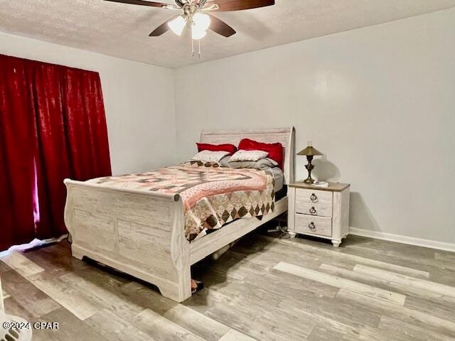 bedroom featuring ceiling fan and hardwood / wood-style flooring