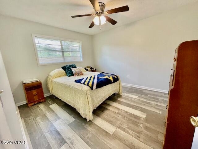 bedroom featuring wood-type flooring and ceiling fan