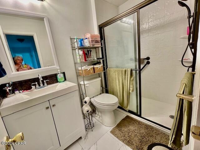 bathroom featuring walk in shower, vanity, and toilet