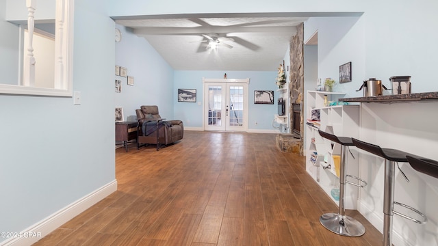 hallway featuring vaulted ceiling with beams, french doors, and hardwood / wood-style flooring