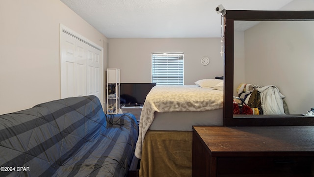 bedroom with a closet and a textured ceiling