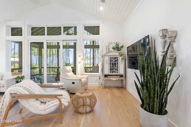 sunroom featuring plenty of natural light and lofted ceiling