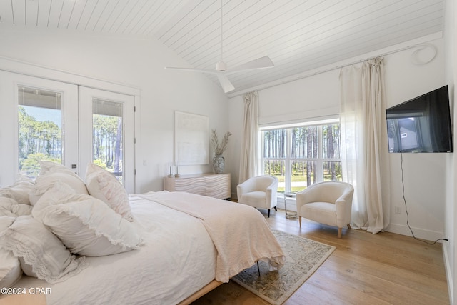 bedroom featuring access to outside, light hardwood / wood-style flooring, wood ceiling, vaulted ceiling, and french doors