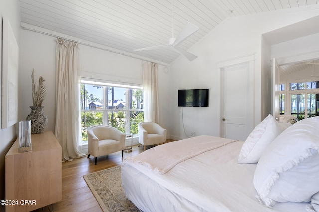 bedroom with hardwood / wood-style floors, vaulted ceiling, and wood ceiling