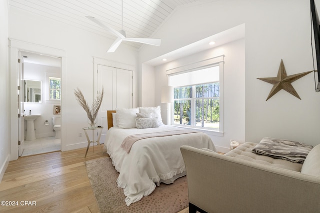 7507 Loons Call Ln, Panama City Beach, FL 32413 - bedroom featuring light wood-style flooring, ensuite bathroom, multiple windows, and lofted ceiling