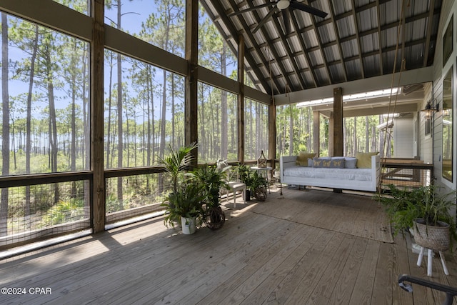 unfurnished sunroom with ceiling fan and vaulted ceiling