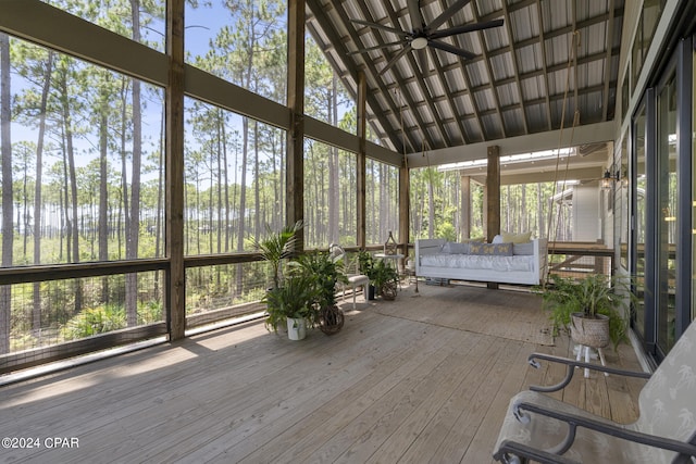 unfurnished sunroom with ceiling fan and lofted ceiling