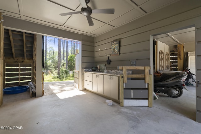 interior space with ceiling fan and sink