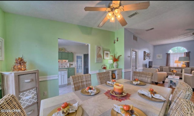 dining room featuring ceiling fan, light tile patterned floors, and a textured ceiling