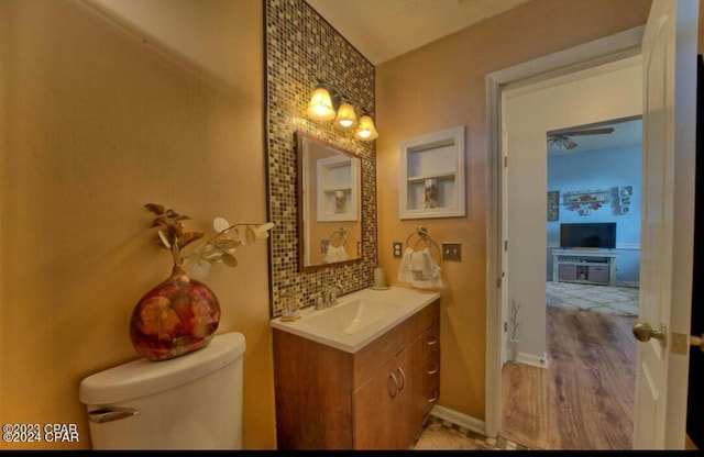 bathroom featuring hardwood / wood-style floors, toilet, and vanity