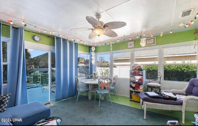 sunroom / solarium featuring ceiling fan