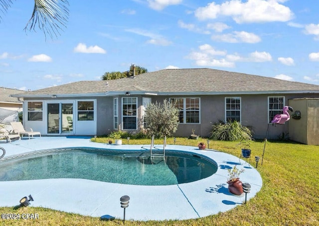 view of pool featuring a lawn and a patio